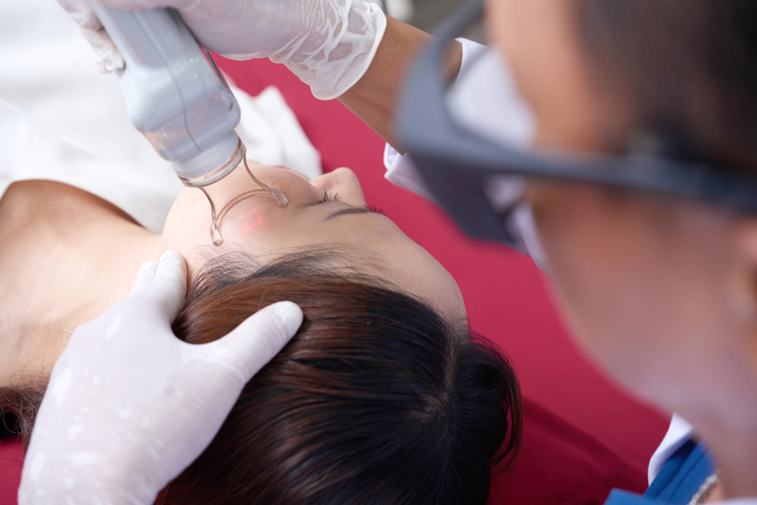 Doctor performing a facial skin treatment on a patient