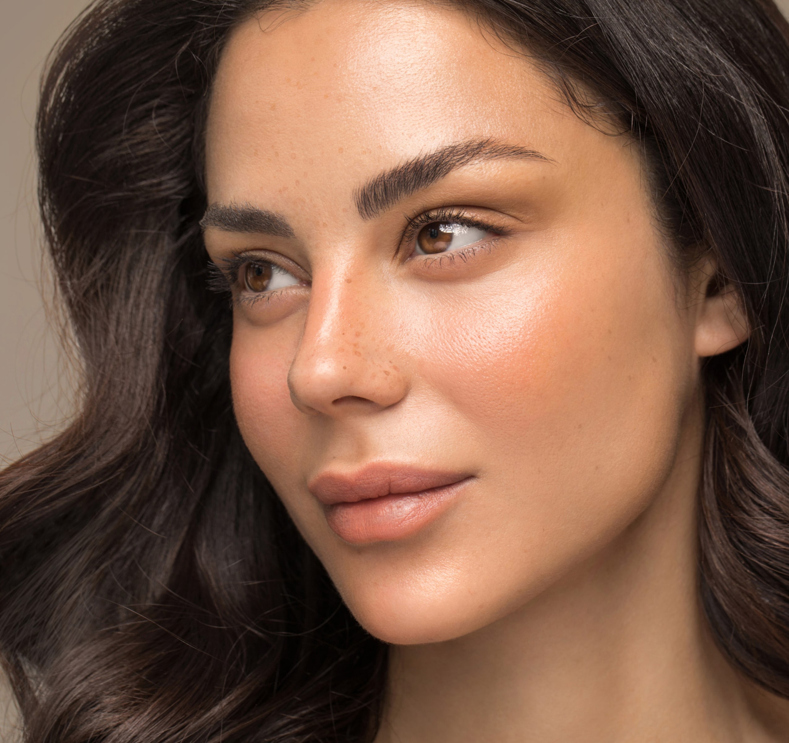 Patient receiving a non-invasive aesthetic facial treatment in clinic