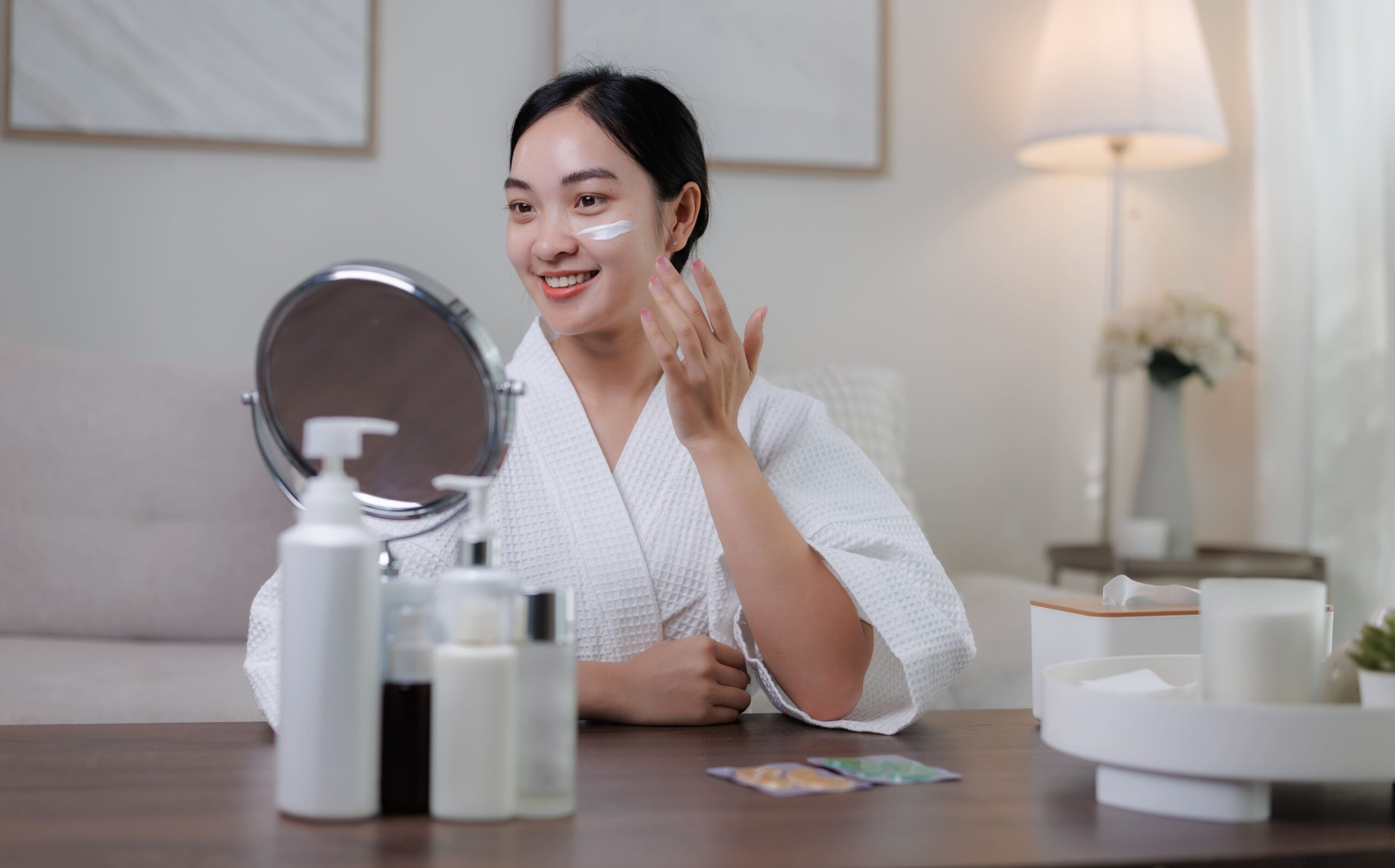 smiling woman applying face cream at home 2026 03 25 09 47 35 utc 1 scaled